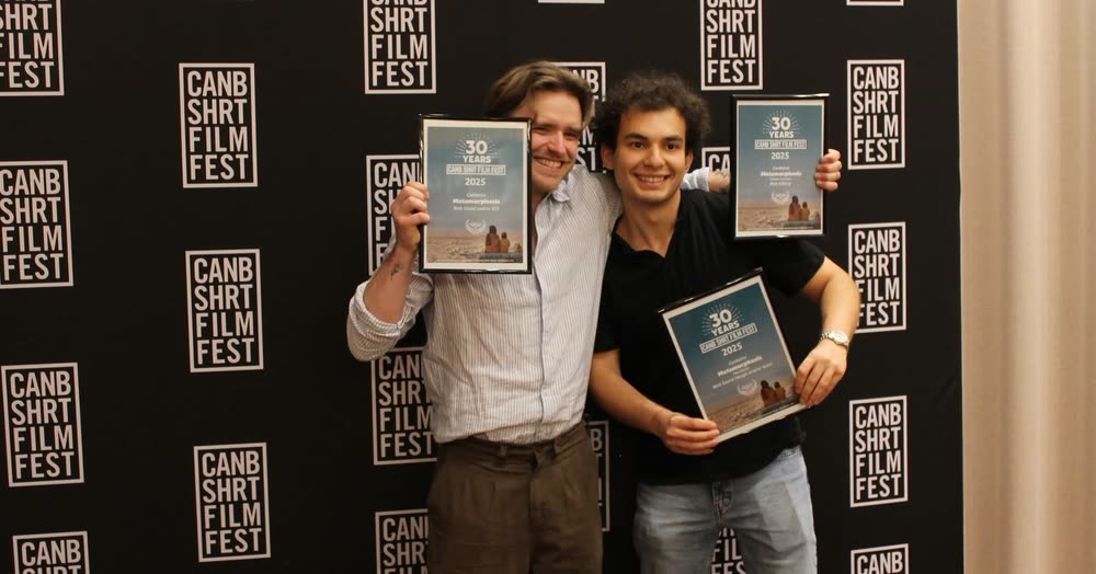 Mert Boyali and filmmaker Callum Lawrence holding a Canberra Short Film Festival award for Metamorphosis
